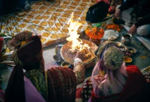 man cooking food in a bonfire