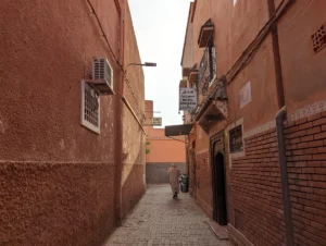 a person walking down a narrow alley way