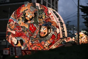 A large decorated umbrella sitting on the side of a road