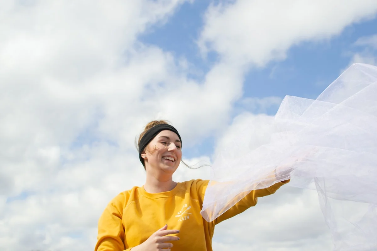 woman holding white veil