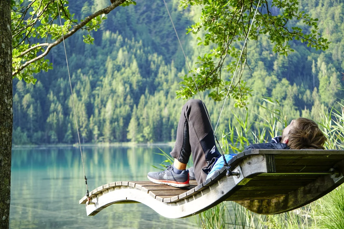 Guy in front of a blue lake in Austria