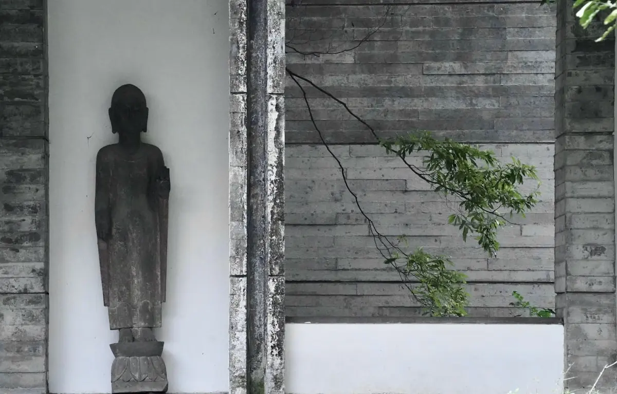 a statue of a man standing next to a building