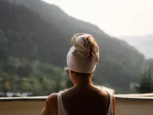 Woman with towel on head looking at mountains